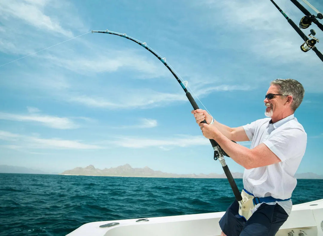 Man fishing on a boat with monofilament line over blue sea, 4Boats marine gear