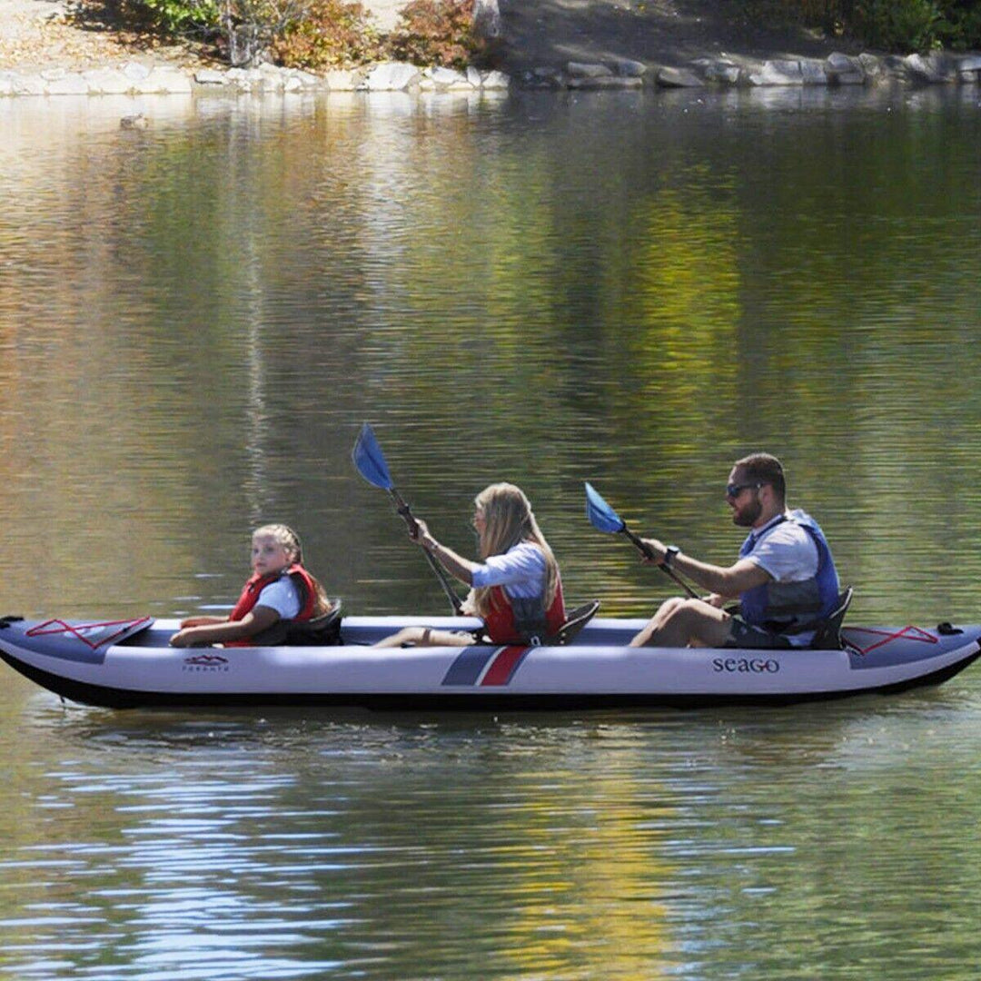 Family kayaking on calm lake in inflatable Seago kayak, wearing life jackets, outdoor boating