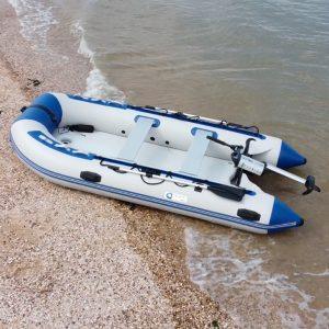 Inflatable dinghy with electric outboard motor ashore on a beach, 4Boats marine accessories