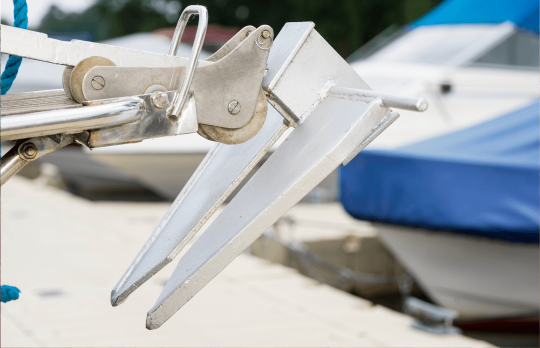 Close-up of a metal boat anchor on a docked vessel at a marina, marine accessories UK