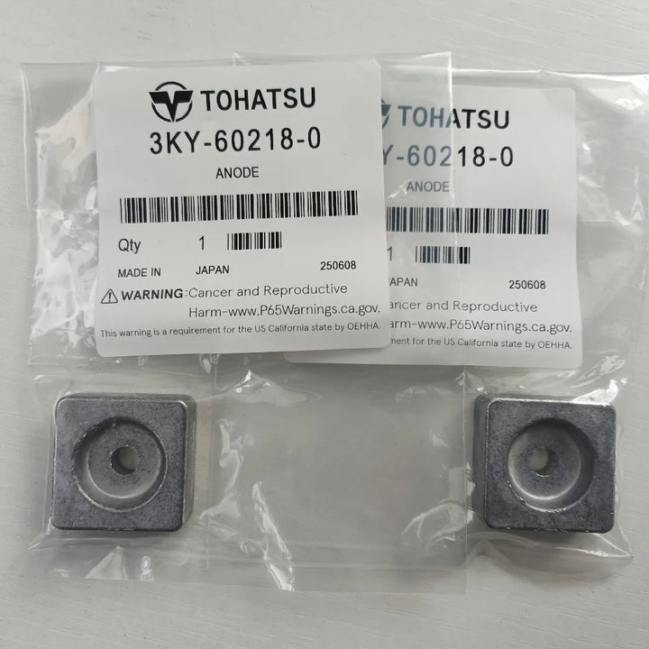 Two metallic anodes in clear packaging with Tohatsu labels on a light gray background