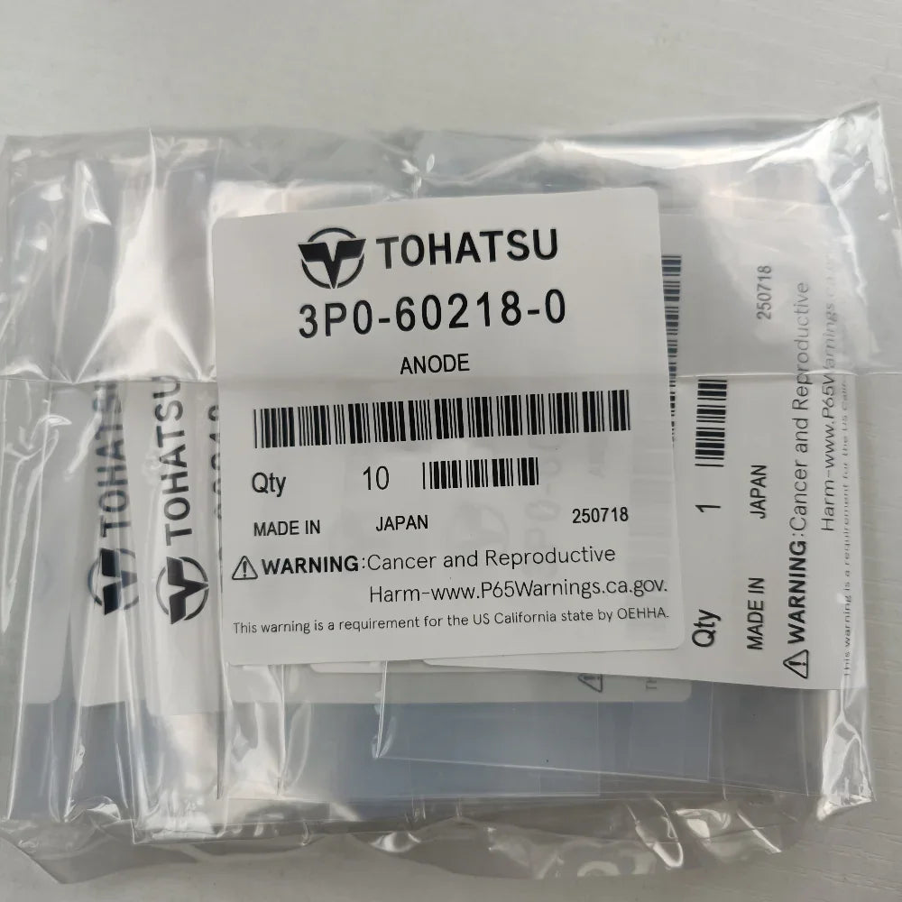 Packaged TOHATSU product with labels and warning stickers on a gray background
