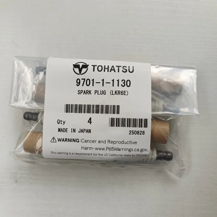 Packaged spark plugs with Tohatsu label on a white background