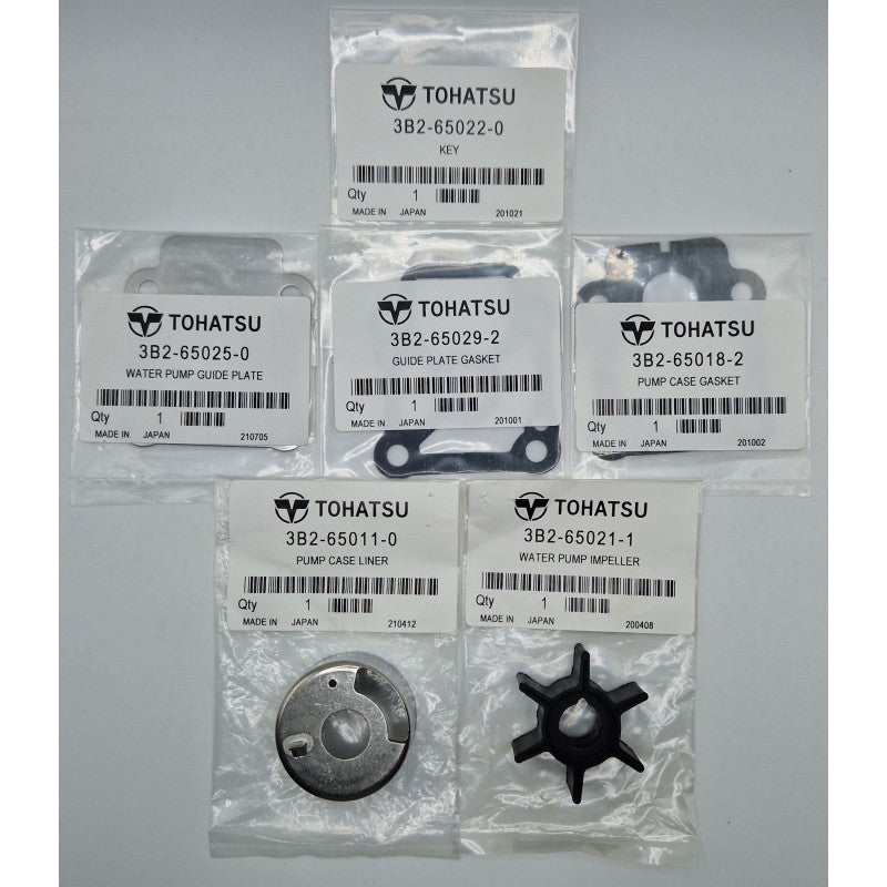 Set of Tohatsu marine engine parts on a gray background