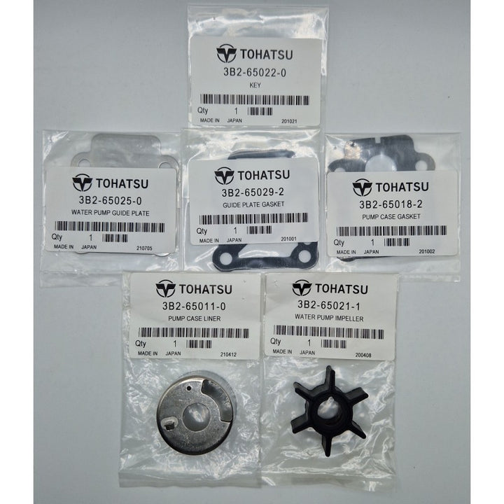 Set of Tohatsu marine engine parts on a gray background