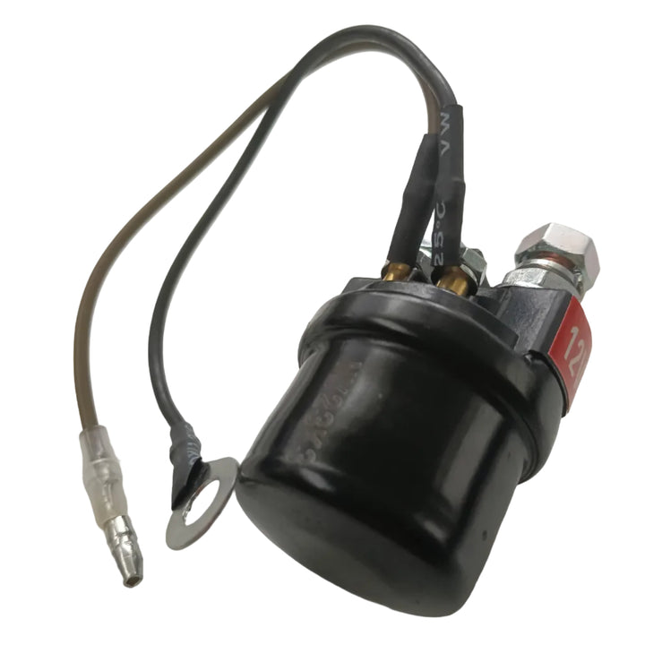A black motorcycle fuel pump with attached wires, a hex nut, and a red label, photographed on a light gray surface.