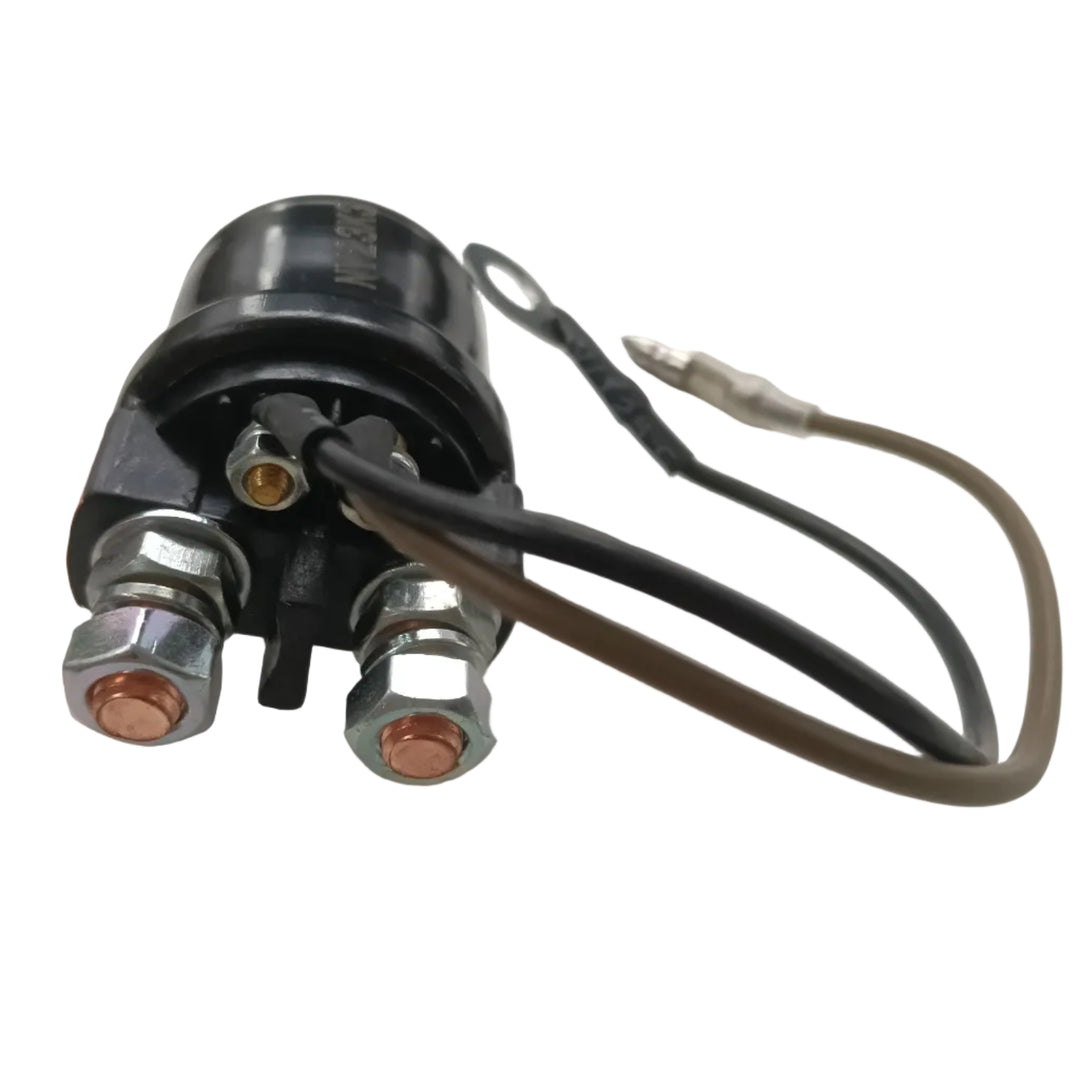 A black electrical relay or solenoid valve with two large silver bolted terminals showing copper contacts, plus two wires (one black, one brown/tan) with a small silver connector, photographed on a light gray surface.