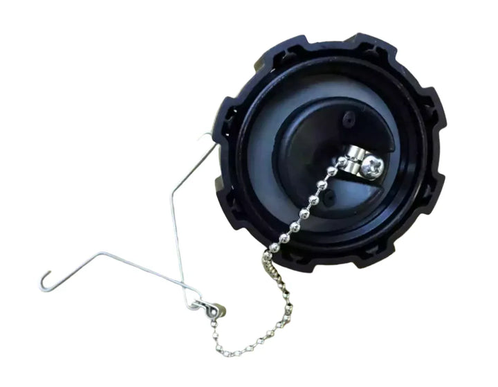 Black cap with chain on a beige background