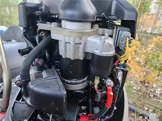 Tohatsu 3KY-76010-0 starter motor fitted on an outboard engine powerhead